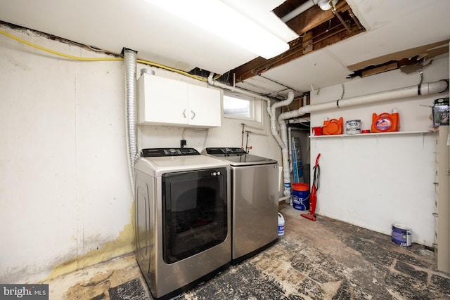 washroom with cabinets and washer and clothes dryer