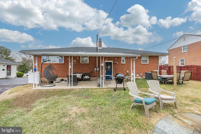 back of house featuring a lawn and a patio