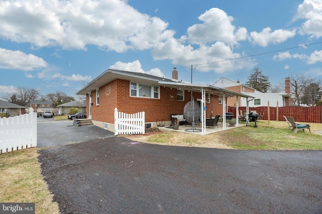 view of front facade with a patio and a front lawn