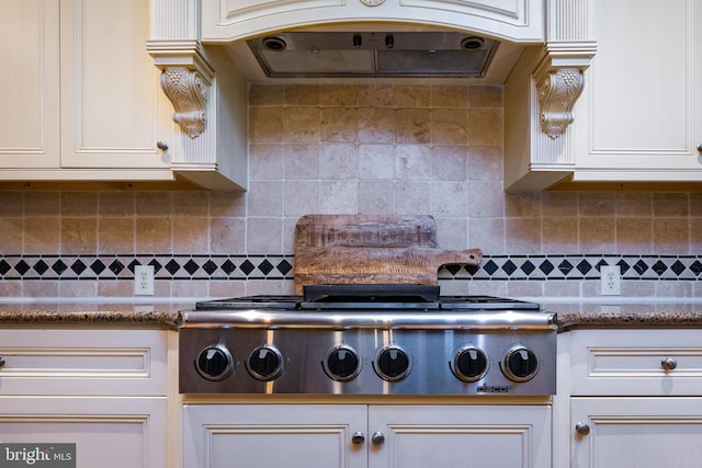 kitchen featuring white cabinets, exhaust hood, and tasteful backsplash