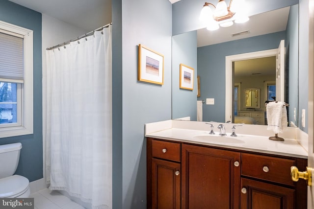 bathroom with tile patterned flooring, vanity, toilet, and a shower with curtain