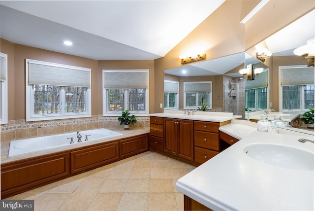 bathroom with tile patterned flooring, vanity, plus walk in shower, and vaulted ceiling