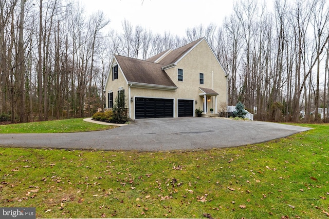 view of property exterior featuring a garage and a yard