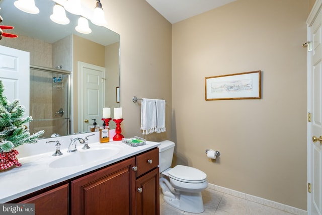 bathroom featuring tile patterned floors, vanity, a shower with shower door, and toilet