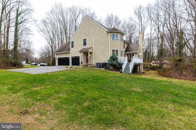 exterior space featuring a yard, a garage, and a deck