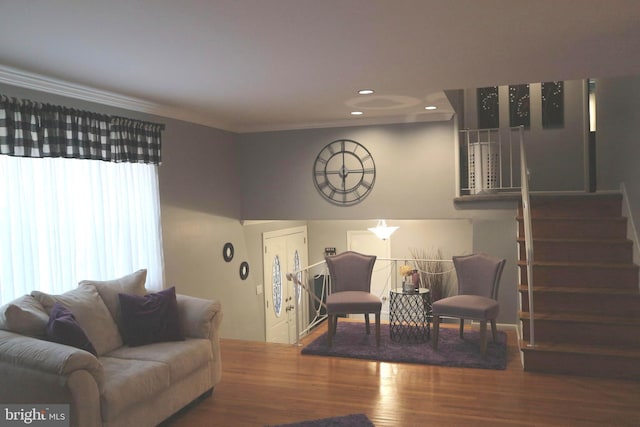 living room with wood-type flooring and crown molding