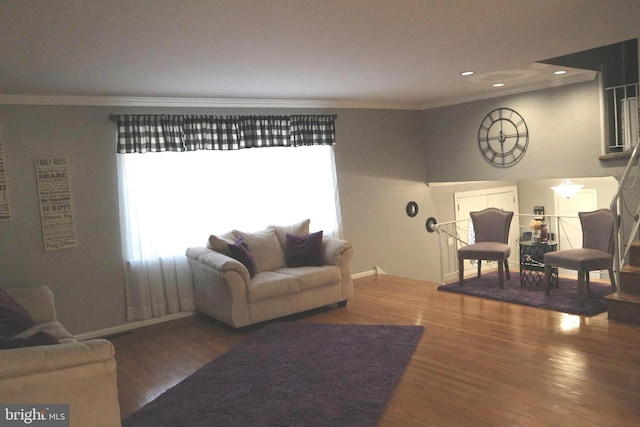 living room with dark hardwood / wood-style floors and ornamental molding