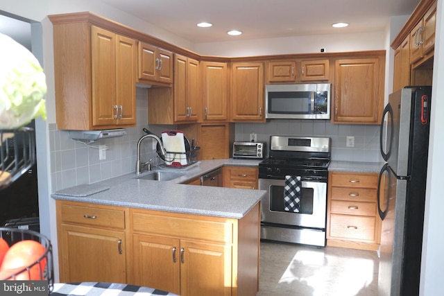 kitchen with tasteful backsplash, sink, and stainless steel appliances