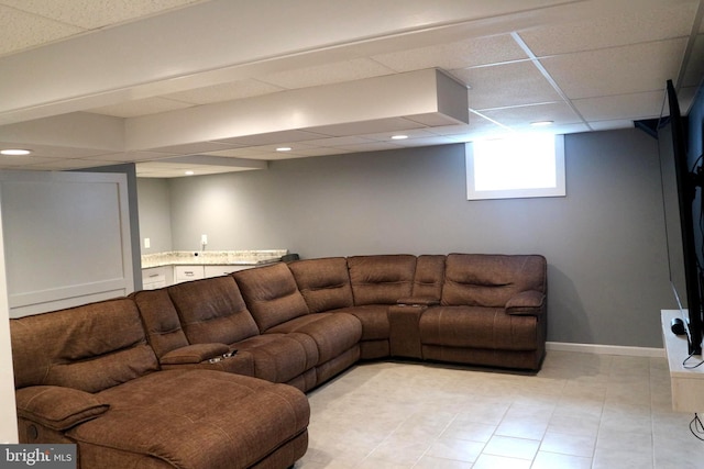 living room with a paneled ceiling