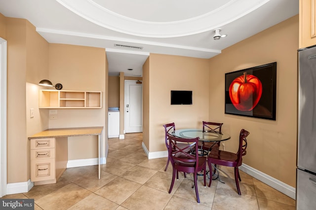 dining area with built in desk and light tile patterned floors