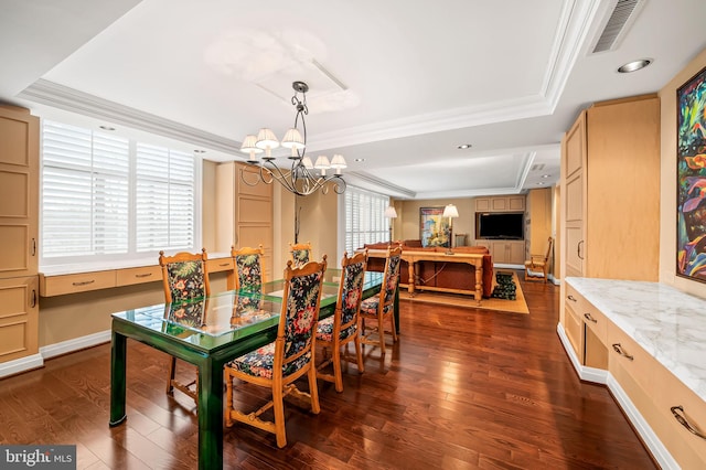 dining space with crown molding, a tray ceiling, and dark hardwood / wood-style floors