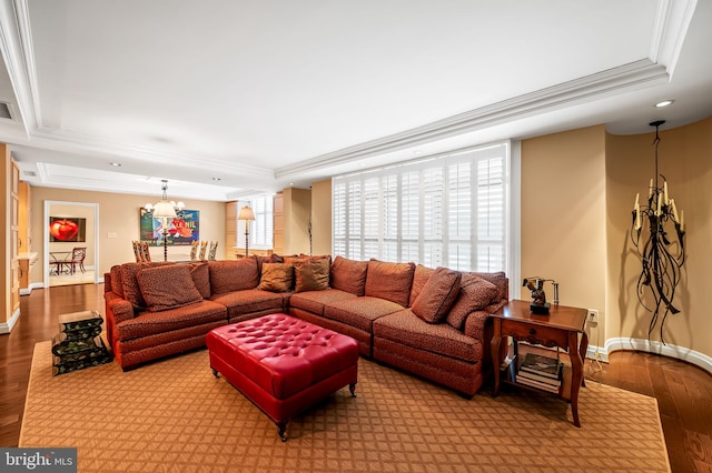 living room featuring hardwood / wood-style flooring, ornamental molding, and a tray ceiling