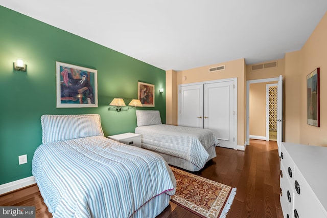 bedroom featuring a closet and dark hardwood / wood-style floors