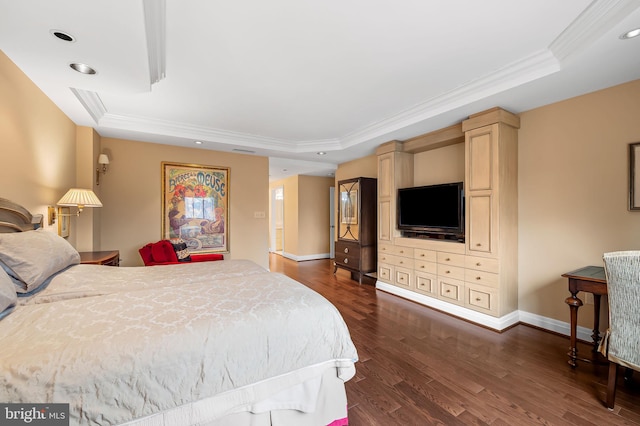 bedroom featuring dark wood-type flooring, ornamental molding, and a raised ceiling