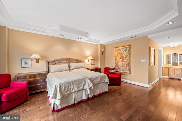 bedroom featuring wood-type flooring, ornamental molding, and a raised ceiling