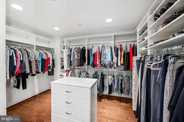 walk in closet with hardwood / wood-style flooring