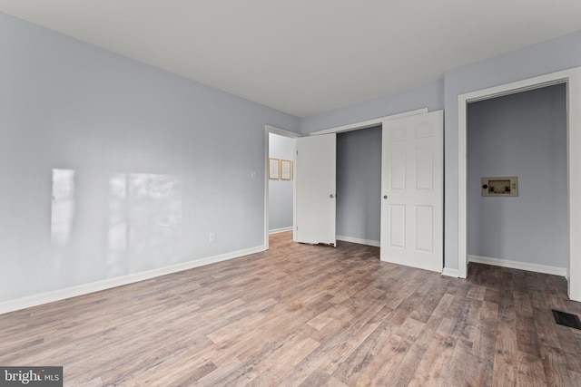 unfurnished bedroom featuring hardwood / wood-style floors