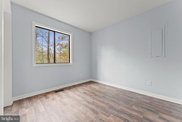 unfurnished room with wood-type flooring