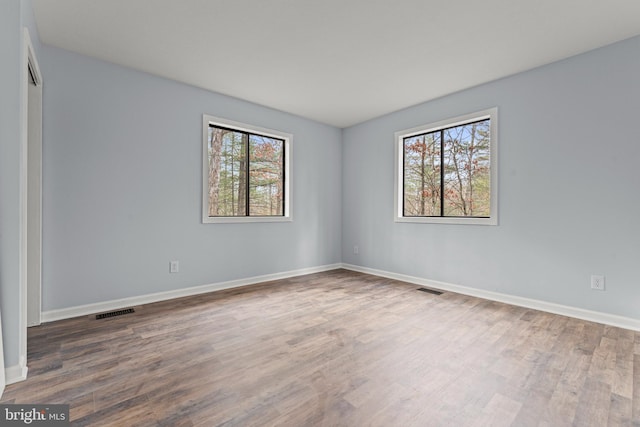 unfurnished room featuring hardwood / wood-style floors