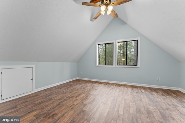 additional living space with lofted ceiling, ceiling fan, wood-type flooring, and a textured ceiling