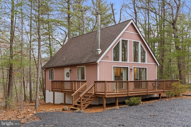 rear view of house featuring a deck