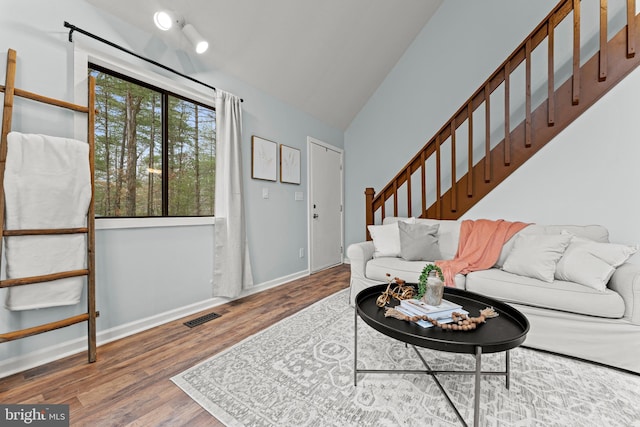 living room featuring hardwood / wood-style flooring and lofted ceiling