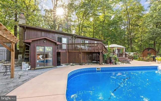 view of swimming pool featuring a wooden deck