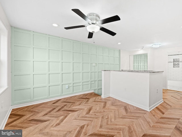 empty room featuring ceiling fan and light parquet floors