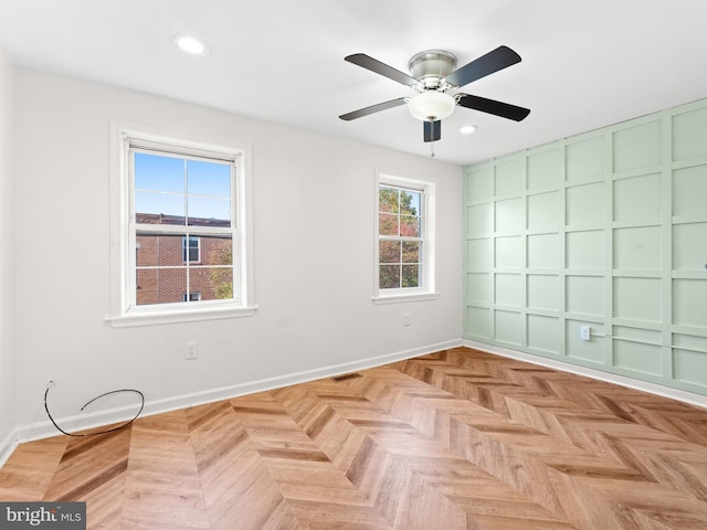 unfurnished room featuring light parquet floors and ceiling fan