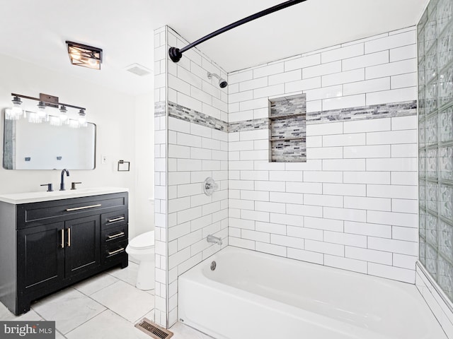 full bathroom featuring vanity, toilet, and tiled shower / bath