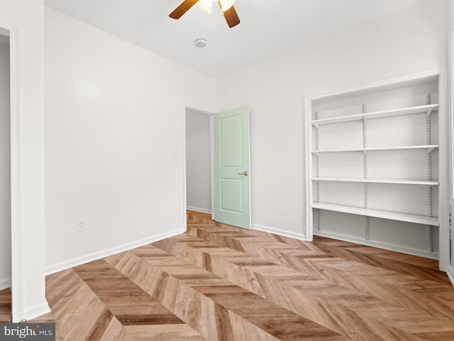 unfurnished bedroom with light parquet floors and ceiling fan