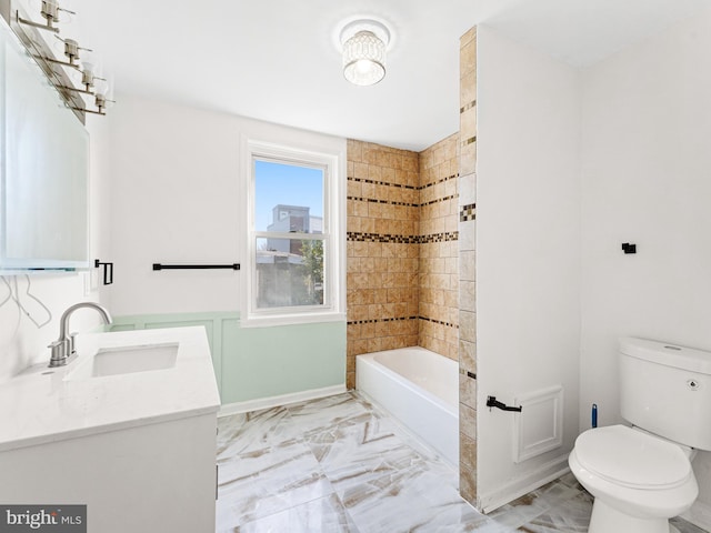 full bathroom with vanity, tiled shower / bath, and toilet