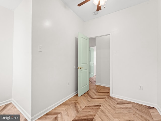 spare room featuring parquet flooring and ceiling fan