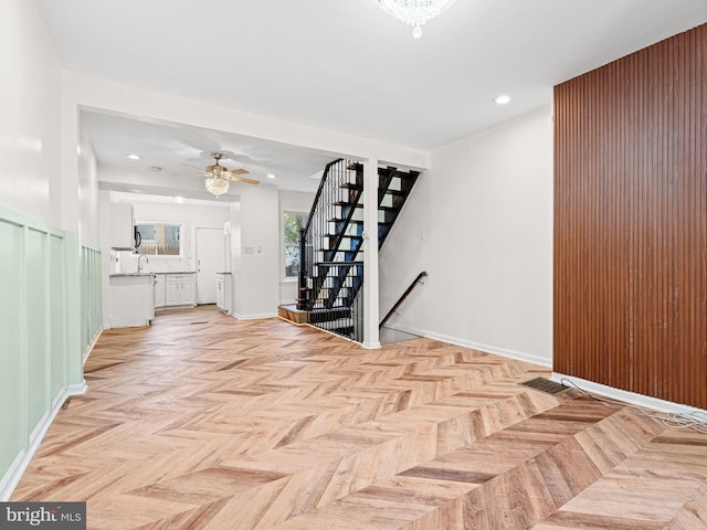 interior space with light parquet flooring and ceiling fan