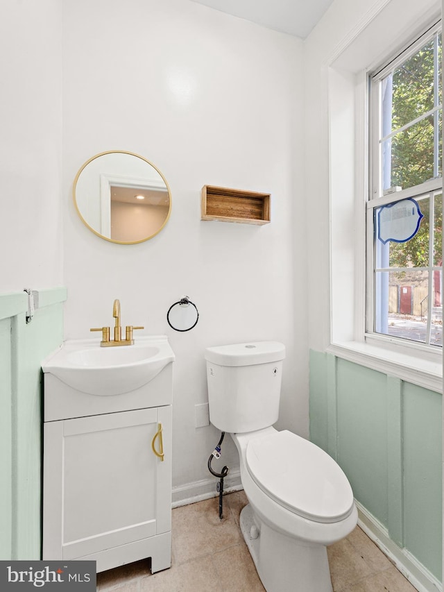 bathroom featuring tile patterned floors, vanity, and toilet