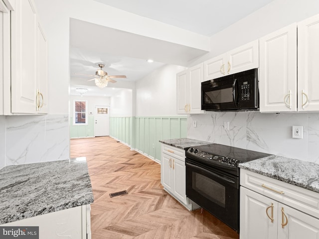 kitchen with decorative backsplash, light parquet floors, ceiling fan, black appliances, and white cabinetry