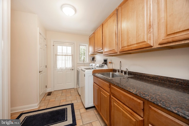 laundry area featuring cabinets, washer and dryer, and sink