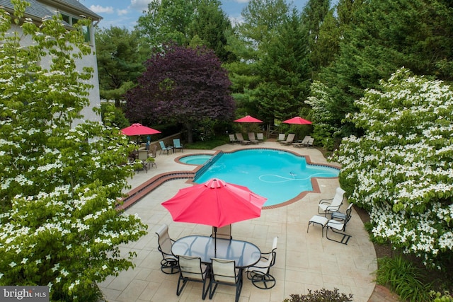 view of pool featuring a patio and an in ground hot tub