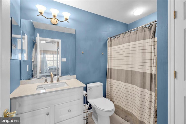 bathroom featuring tile patterned floors, vanity, toilet, and walk in shower