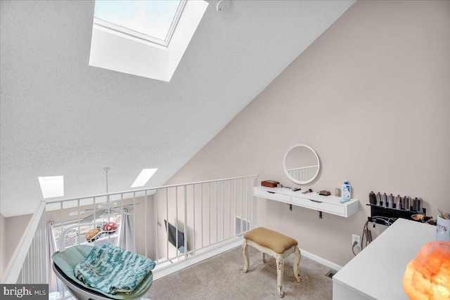 office with ceiling fan, carpet floors, lofted ceiling with skylight, and a textured ceiling