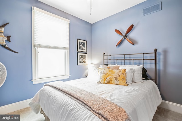 carpeted bedroom with multiple windows