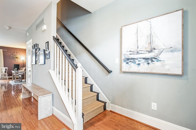 stairway with hardwood / wood-style floors