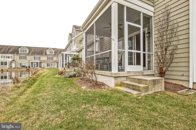 exterior space with a yard and a sunroom