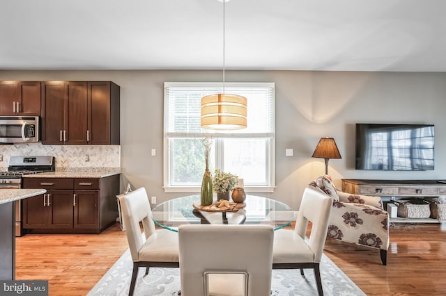 dining space with light hardwood / wood-style floors