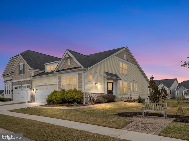 view of front of home featuring a front lawn, driveway, stone siding, a shingled roof, and a garage