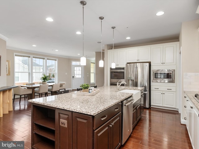 kitchen featuring a center island with sink, white cabinetry, dark brown cabinetry, appliances with stainless steel finishes, and dark wood-style flooring