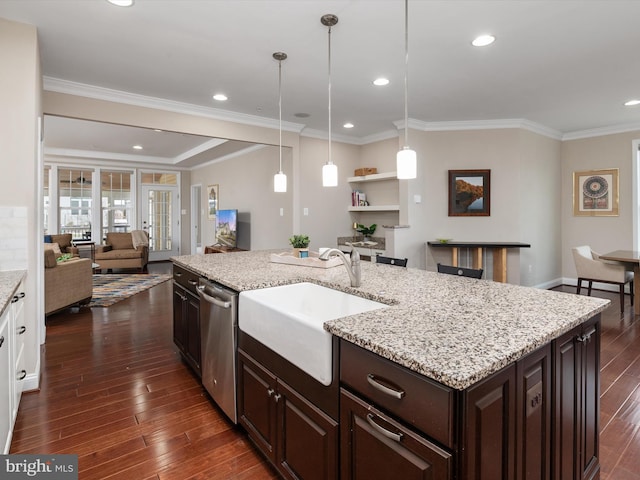 kitchen featuring dark wood-style flooring, a sink, dark brown cabinets, stainless steel dishwasher, and open floor plan