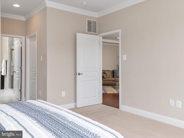 carpeted bedroom featuring recessed lighting, visible vents, baseboards, and crown molding