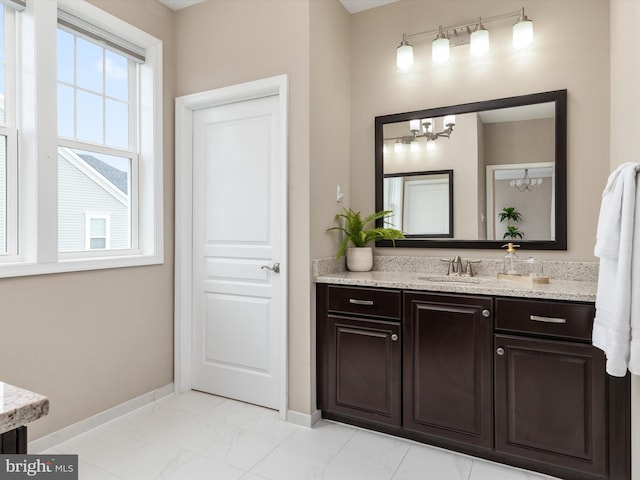 bathroom with vanity and baseboards