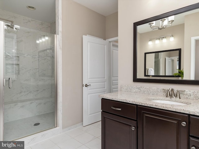 bathroom featuring tile patterned floors, baseboards, vanity, and a shower stall